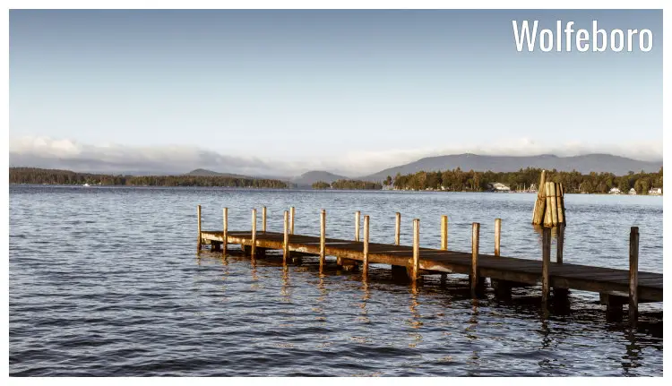 A long wooden pier on the water, docking point for small boats and yachts on Lake Winnipesaukee in Wolfeboro, New Hampshire