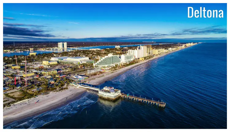 The iconic Daytona Beach in Deltona, Florida, with a long pier, summer house, and a scenic cityscape The iconic Daytona Beach in Deltona, Florida, with a long pier, summer house, and a scenic cityscape