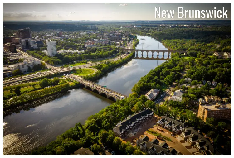 An aerial panorama of the city of Brunswick, New Jersey, seen with its deep tree cover, a large river, and bridges over the river