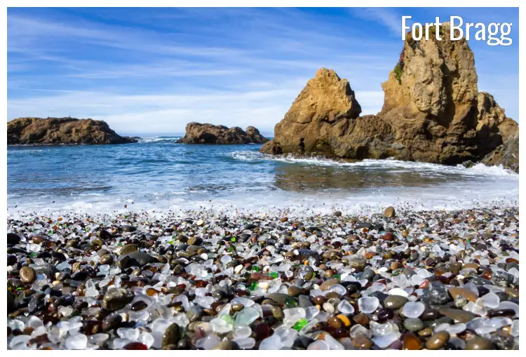 Colorful and shiny stone and glass pebbles blanket at the beach in Fort Bragg, California