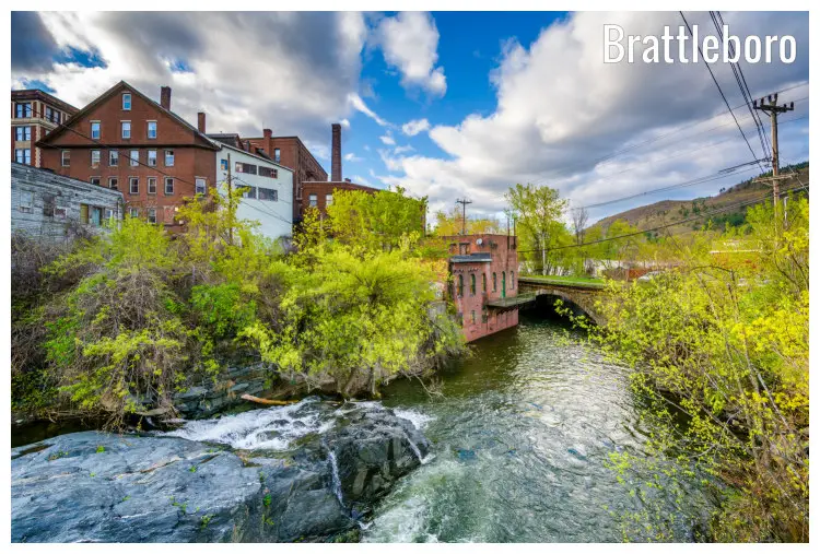 A hilly landscape in Brattleboro, Vermont, with scenic light green vegetation around the old buildings and cascades A hilly landscape in Brattleboro, Vermont, with scenic light green vegetation around the old buildings and cascades