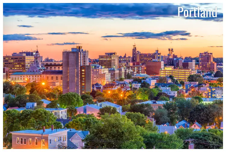Dusk view of the lit skyscrapers of the Portland city in Maine