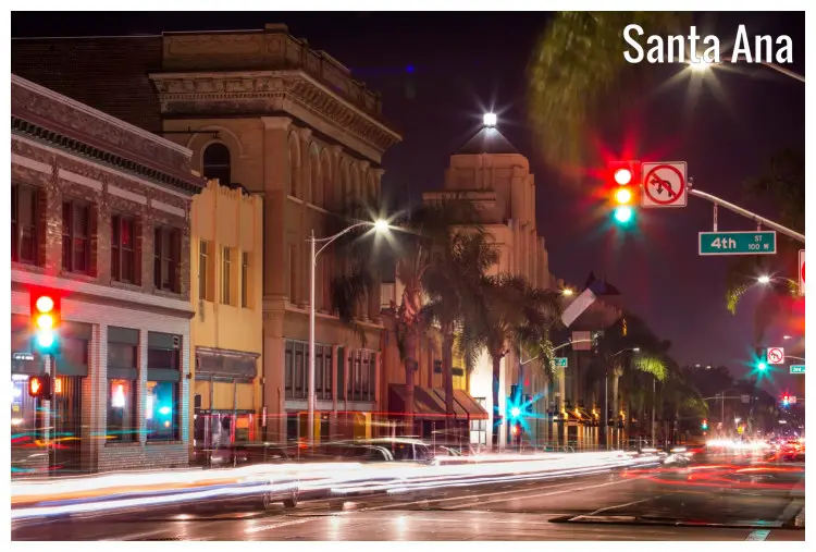 Night lights of the street in Santa Ana, California, with palm trees lining the street Night lights of the street in Santa Ana, California, with palm trees lining the street